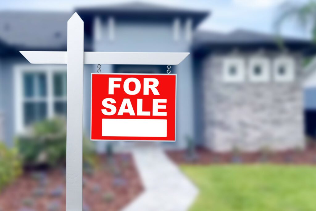 Home For Sale Real Estate Sign and Beautiful New House